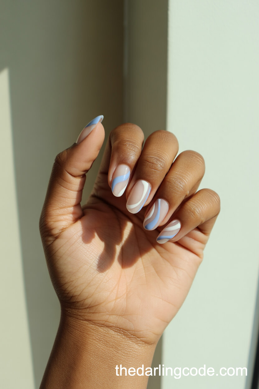 Alternating Pastel Blue And White Swirl Almond Nails