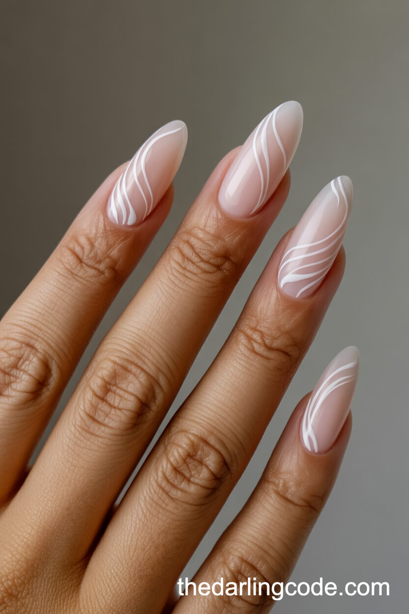 Almond Nude Nails With White Swirl Art