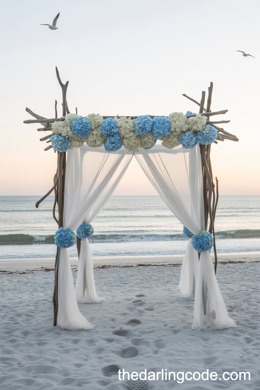 Driftwood Arbor With Chiffon And Hydrangeas On The Beach