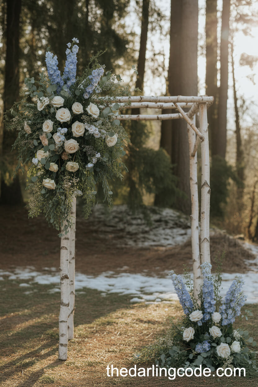 Birchwood Arch With Blue Delphiniums And Snowy Greenery